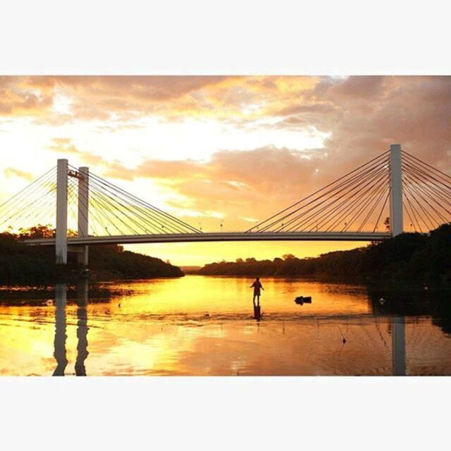 connection, sunset, bridge - man made structure, built structure, sky, architecture, silhouette, water, bridge, engineering, river, suspension bridge, cloud - sky, transfer print, sun, orange color, auto post production filter, travel destinations, reflection