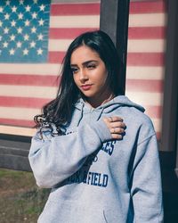 Portrait of beautiful woman against wall