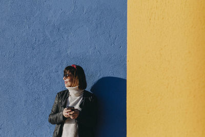 Woman standing against wall