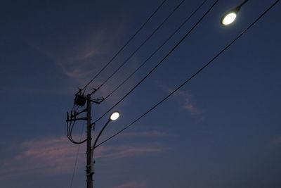 Low angle view of electricity pylon against sky