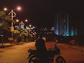 Man with illuminated cityscape at night