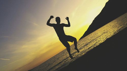 Low angle view of silhouette woman at sunset