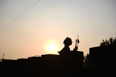 Low angle view of silhouette trees against sky at sunset