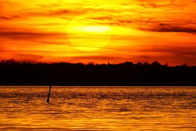 Scenic view of lake at sunset