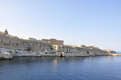 View of buildings against clear blue sky