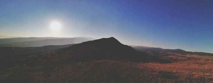 Scenic view of mountains against clear blue sky