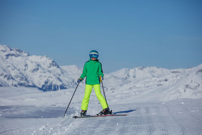 Low section of man skiing on snow covered mountain