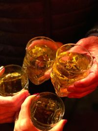 Close-up of people holding glass