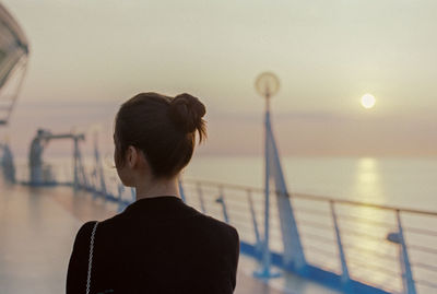 Rear view of woman looking at sea against sky