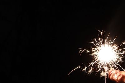 Low angle view of firework display against sky at night