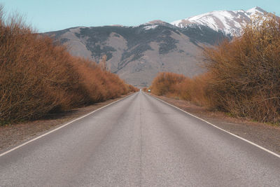 Empty road along mountain range
