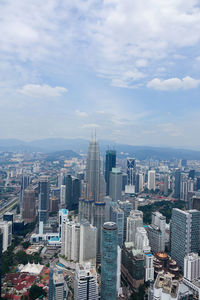 Aerial view of modern buildings in city against sky