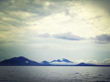 Scenic view of mountains against cloudy sky