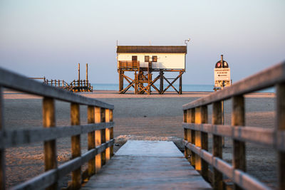 Wooden pier leading towards beach