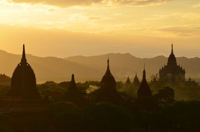 Silhouette temple against sky during sunset