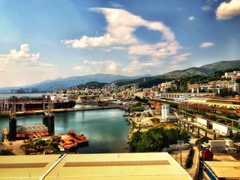 High angle view of river and townscape against sky