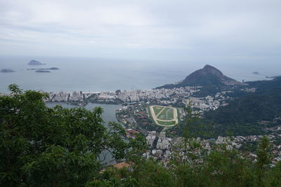 High angle view of sea and mountain against sky