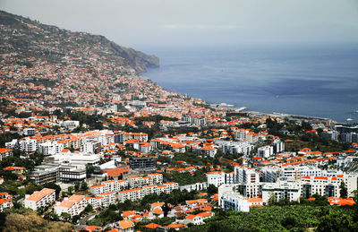 High angle view of residential buildings by sea