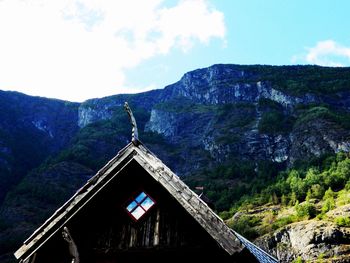 House on mountain against sky