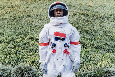 Mid adult woman standing at agricultural field