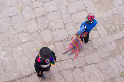 High angle view of men in traditional clothing standing on footpath