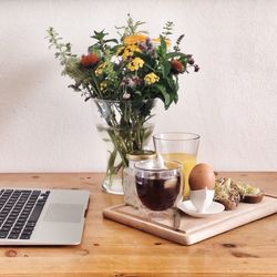 Close-up of breakfast served on table at home office