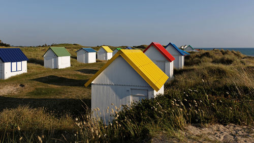 Houses on beach against clear sky