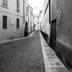 Empty alley amidst buildings in city