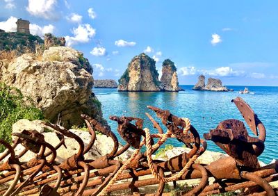 Panoramic view of rocks on beach against sky