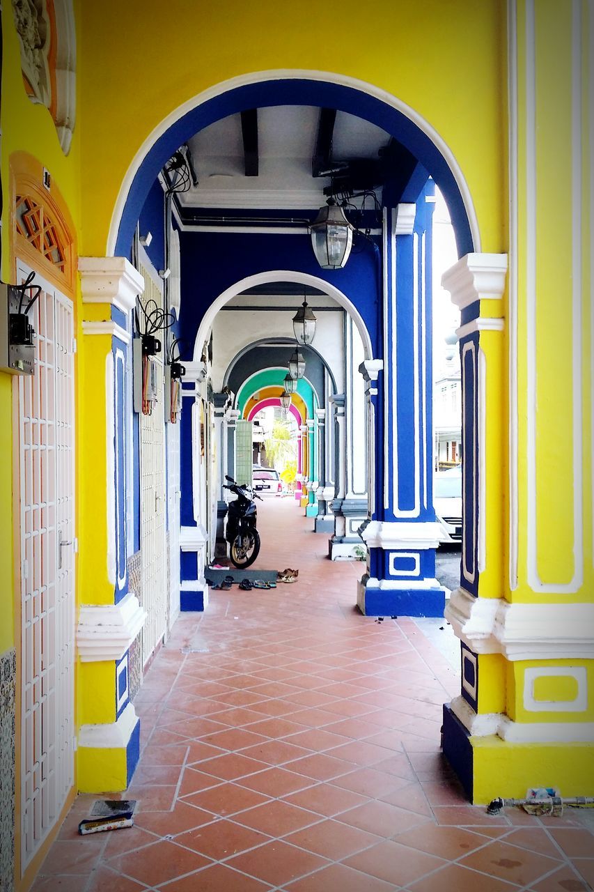 arch, architecture, built structure, yellow, indoors, building exterior, door, the way forward, entrance, archway, empty, building, incidental people, corridor, day, diminishing perspective, narrow, in a row, window, arched