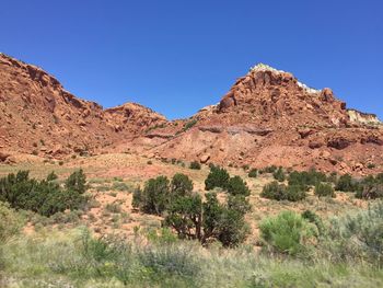 Scenic view of rocky mountains against clear blue sky