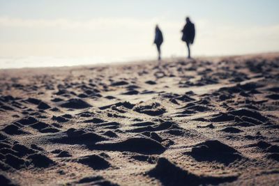 Surface level of water on beach against sky