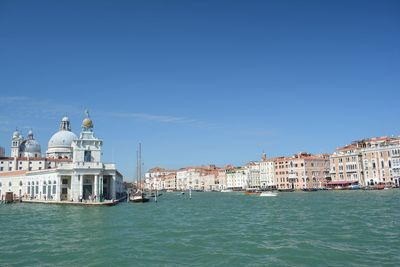 Boats in canal with buildings in background