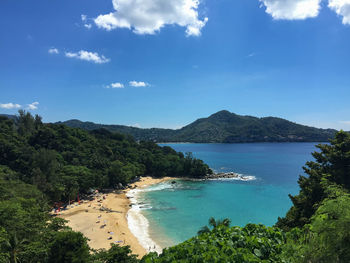 Scenic view of sea and mountains against blue sky