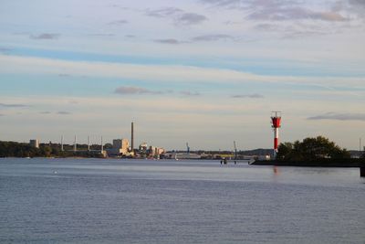 Tower by sea against sky in city