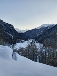 Scenic view of snowcapped mountains against clear sky