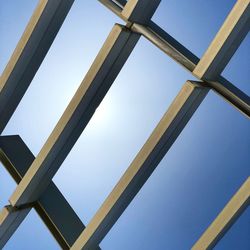 Low angle view of metallic structure against clear blue sky