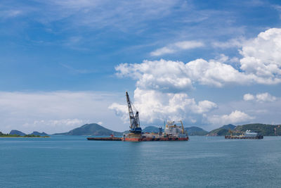 Commercial dock by sea against sky