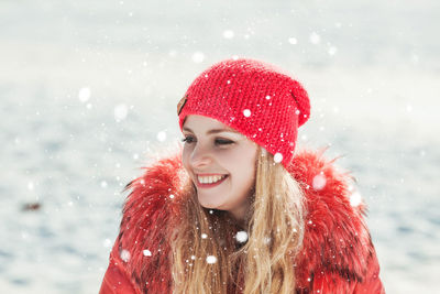 Portrait of a smiling young woman in snow