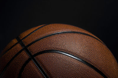 Close-up of basketball hoop against black background