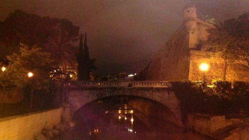 Illuminated bridge at night