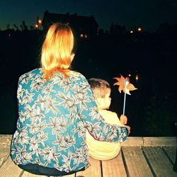 Rear view of woman holding illuminated light painting