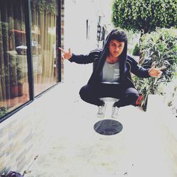 Portrait of smiling young woman sitting outdoors