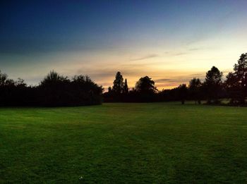 Scenic view of field against sky during sunset