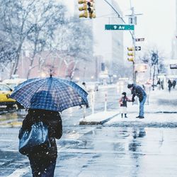 Woman standing on snow covered road