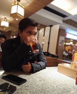 Portrait of a man drinking glass