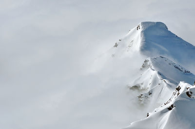 Aerial view of snowcapped mountains against sky