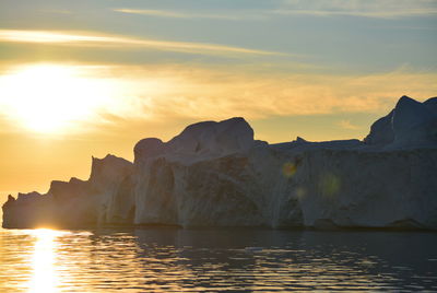 Scenic view of sea against clear sky with beautiful icebergs in the midnight sun ilulissat greenland
