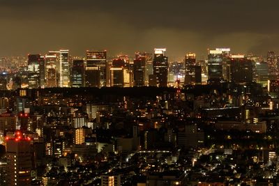 Illuminated cityscape against sky night