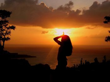 Silhouette of people at sunset